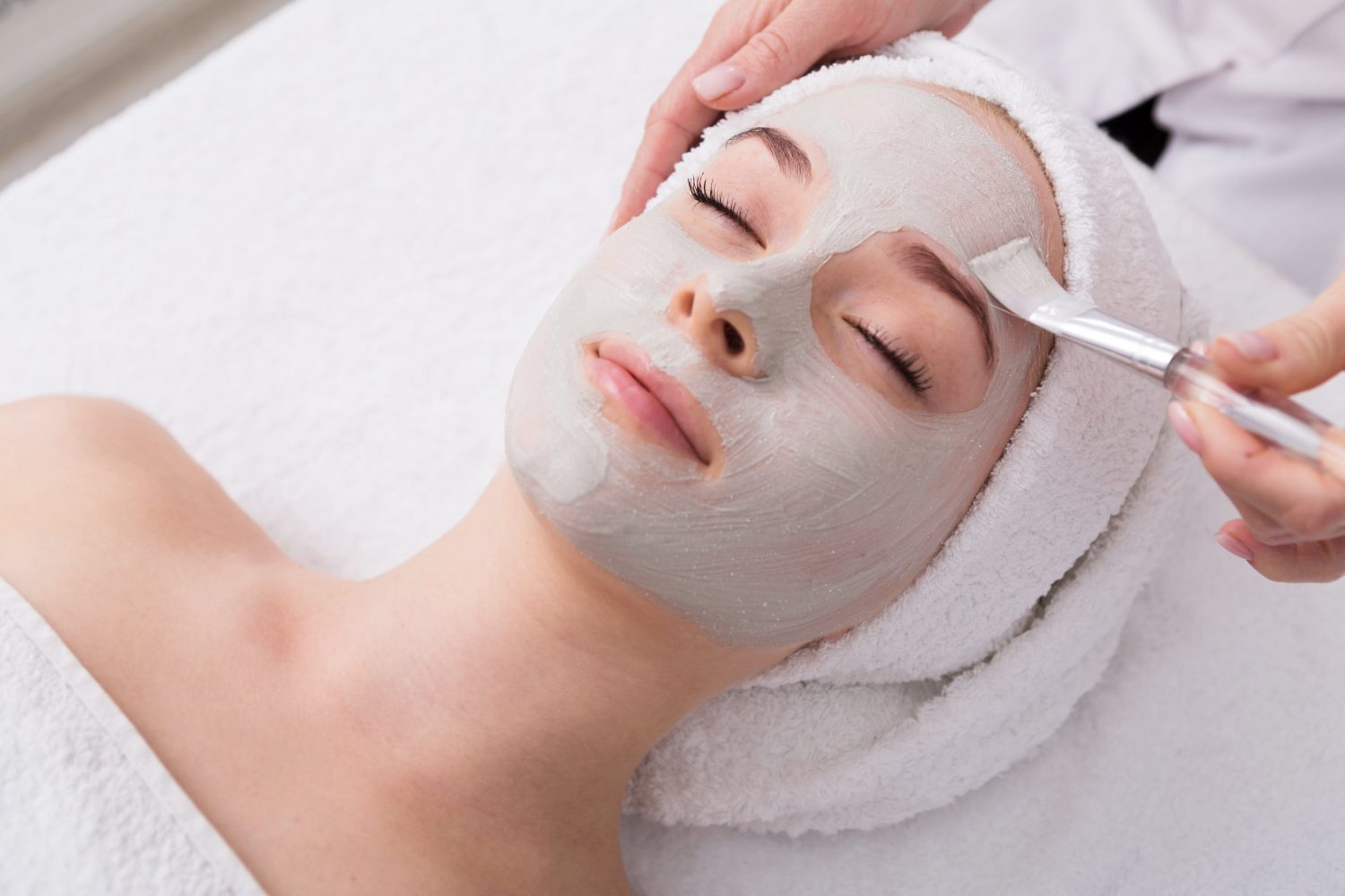 A client receiving a professional facial mask treatment