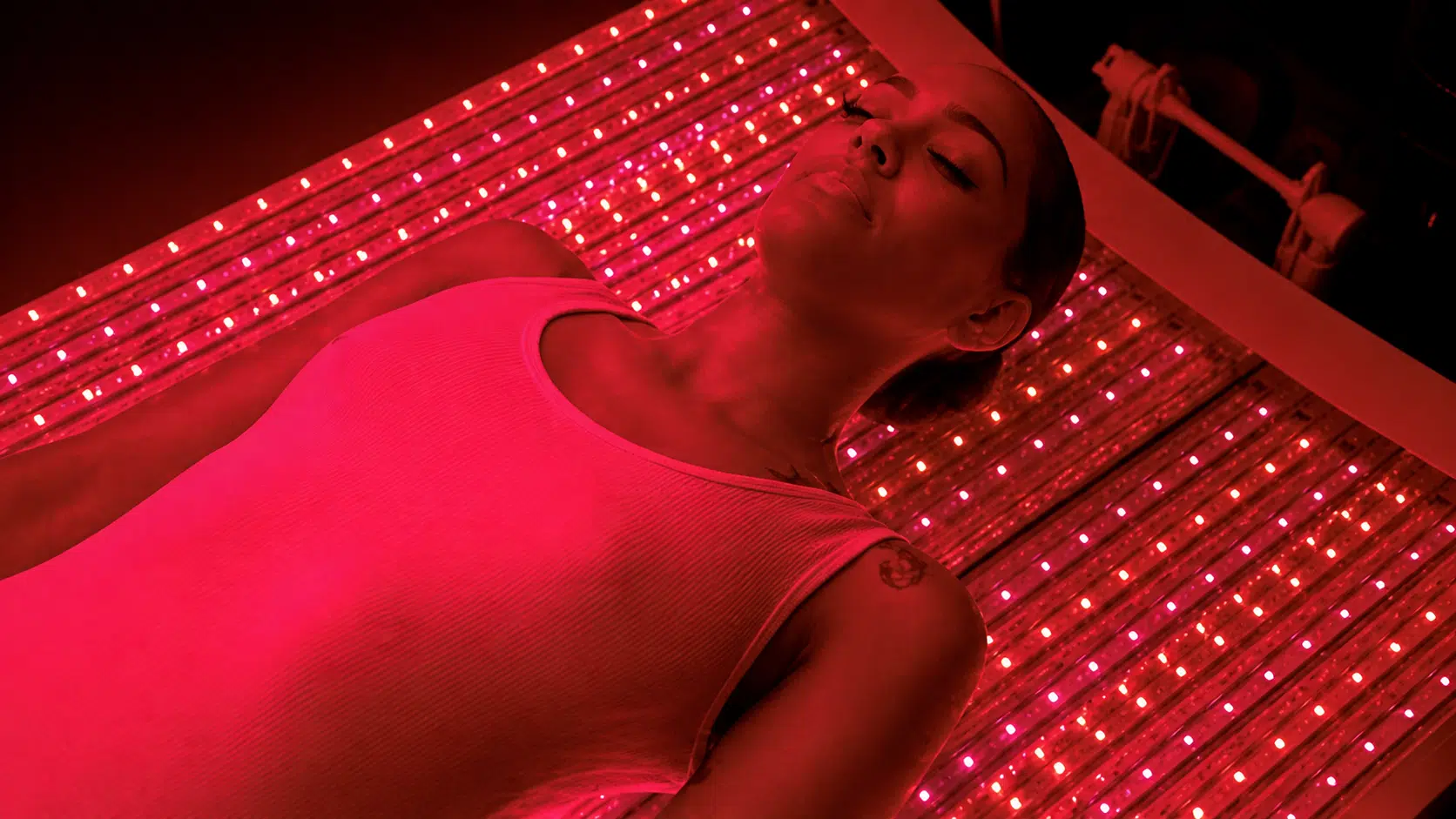 A client resting in the Vital Red Light Vital Bed at All Natural Wellness Center