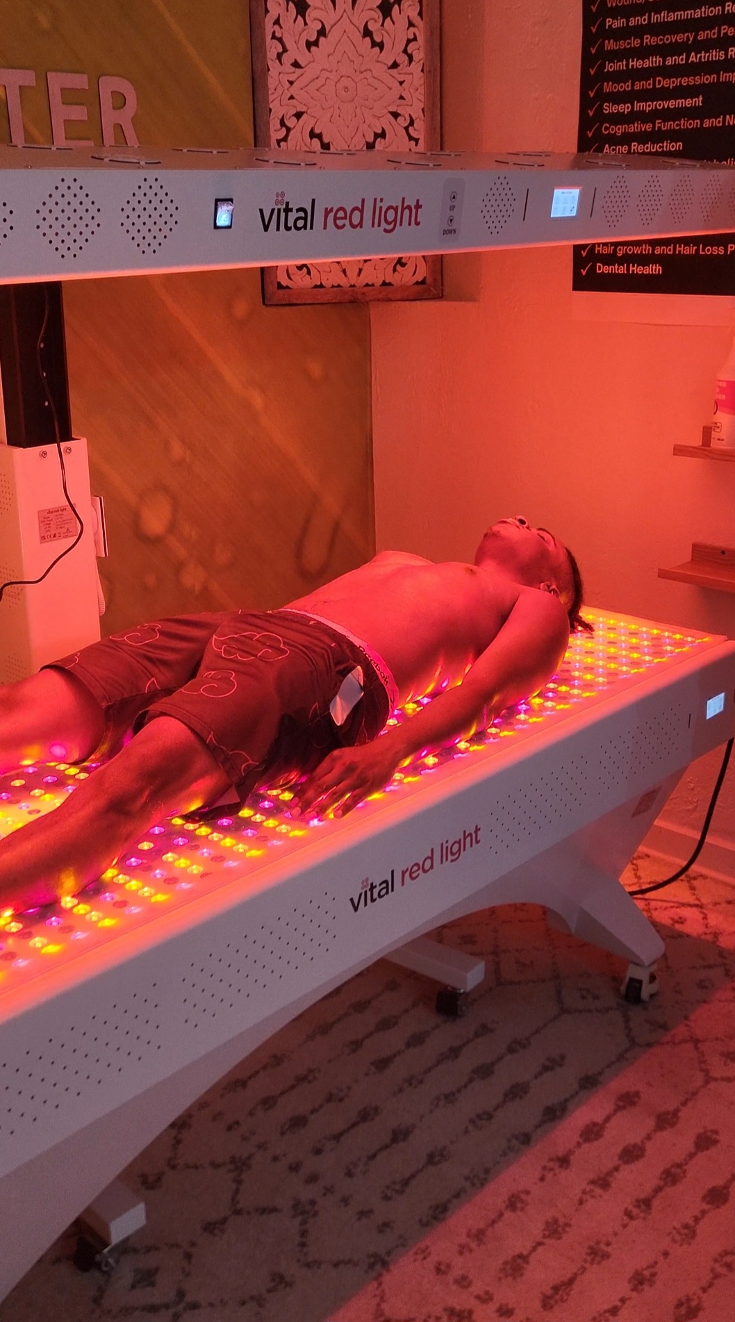 Client resting on the Vital Red Light Vital Bed at All Natural Wellness Center
